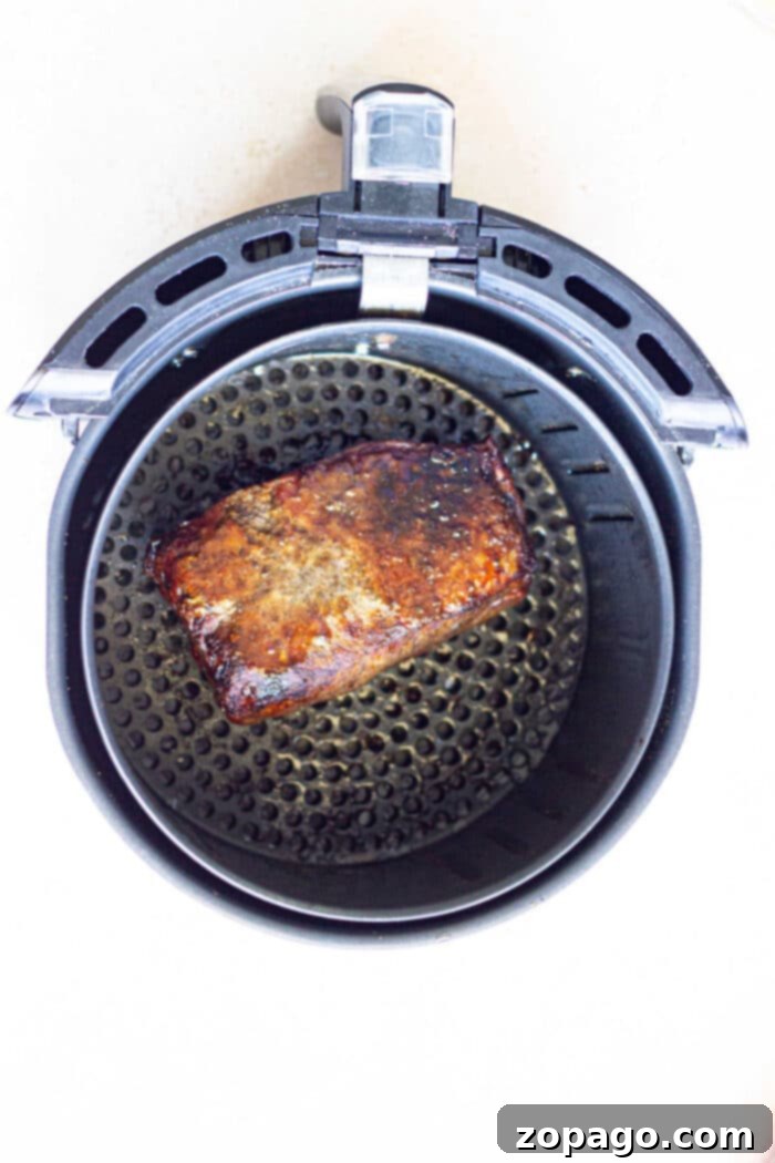 Crispy Air Fryer Frozen Roast 7 A perfectly cooked frozen roast beef, sliced and presented beautifully, showcasing the tender interior and crispy exterior.