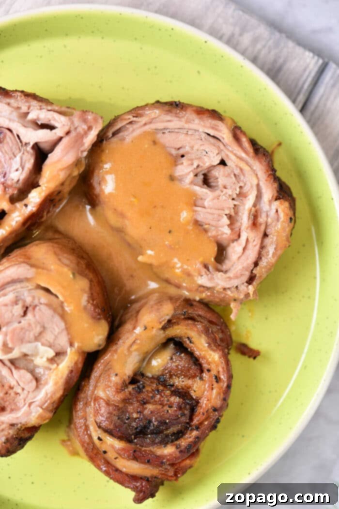 Succulent Lamb Breast 2 Savor the taste of perfectly rolled lamb breast with a luscious gravy, artfully presented on a vibrant green plate, showcasing a delightful blend of flavors.