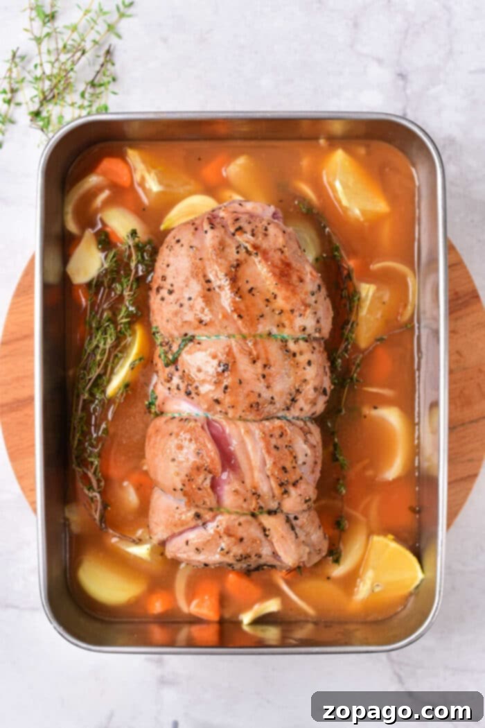 Slow-Braised Lamb Breast 4 Roasted lamb breast in a pan, accompanied by carrots, potatoes, and herbs on a wooden board. For those seeking variation, consider exploring a tender lamb breast recipe that pairs beautifully with similar earthy accompaniments.