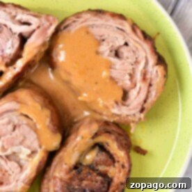 Succulent Lamb Breast 6 Savor the taste of rolled lamb breast with sauce, artfully presented on a green plate. For those intrigued by variety, this dish pairs beautifully with our Lamb Breast Recipe, offering a delightful blend of flavors that's sure to please your palate.