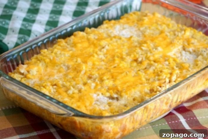 This cream corn casserole recipe, featuring Ritz crackers, Jiffy cornbread mix, and cheese, is a delightful and easy-to-make side for any occasion. A close-up of a delectable cream corn casserole, showcasing its golden, cheesy topping and moist, tender interior, a perfect side dish.