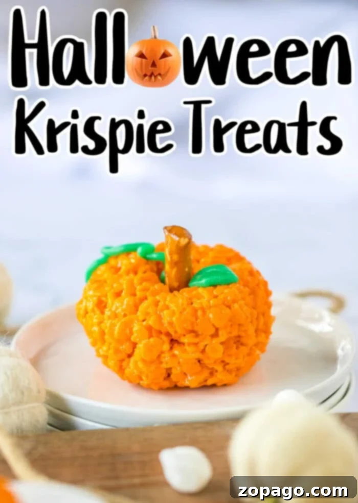 Crispy Autumn Pumpkin Bites 7 Close-up of a festive Rice Krispie Treat for Halloween with green leaf detail.