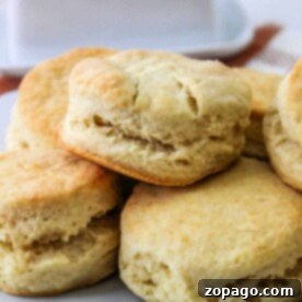 A plate of freshly baked Crisco Biscuits stacked on a white dish.