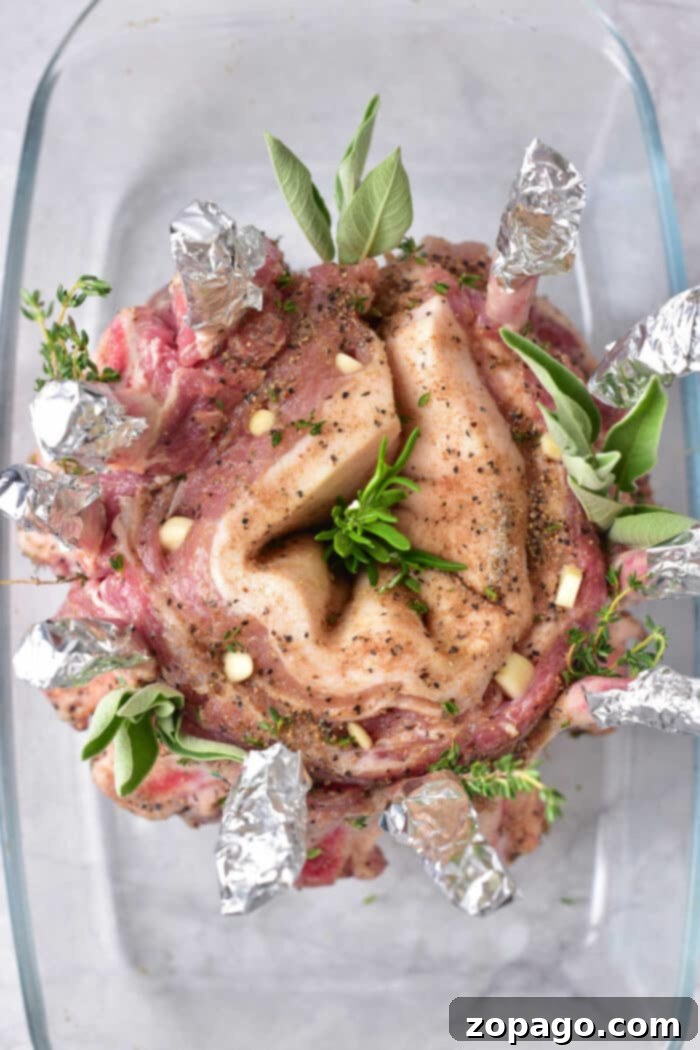 Majestic Pork Crown Roast 4 How to Cook a Crown Roast - A crown roast being prepared on a cutting board, with herbs and spices ready for seasoning.