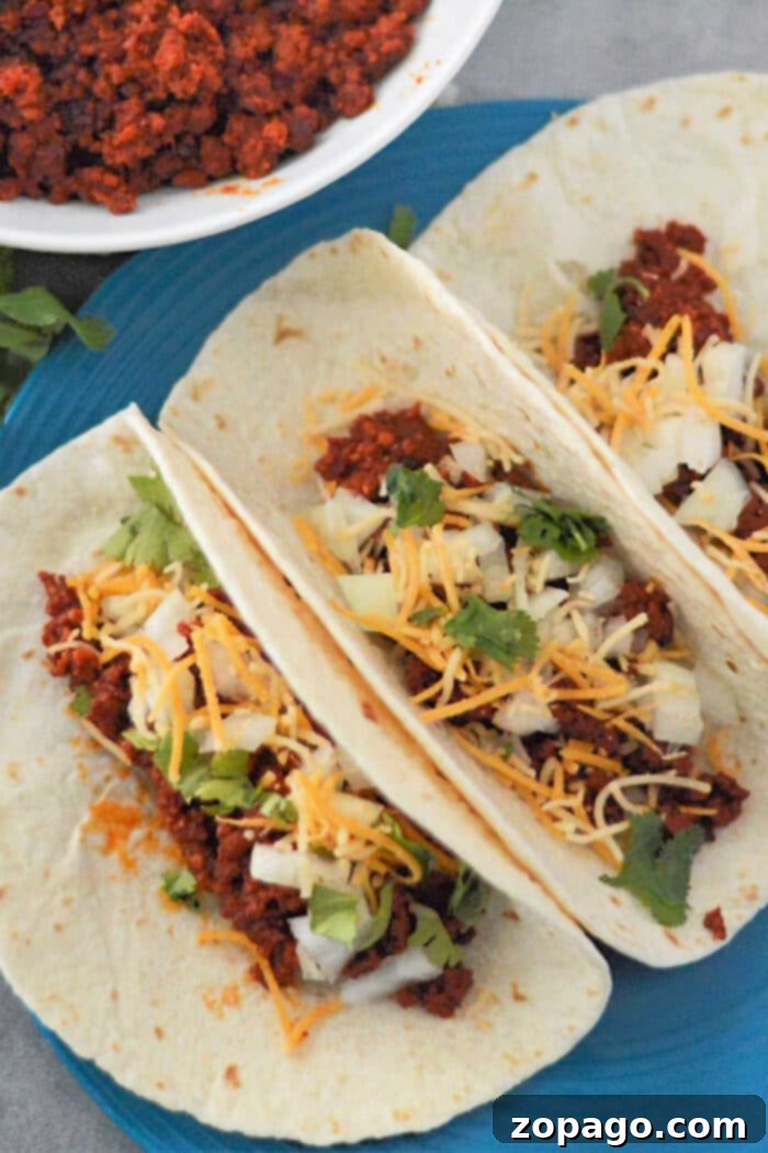 Close-up of a delicious chorizo taco with vibrant toppings and fresh lime
