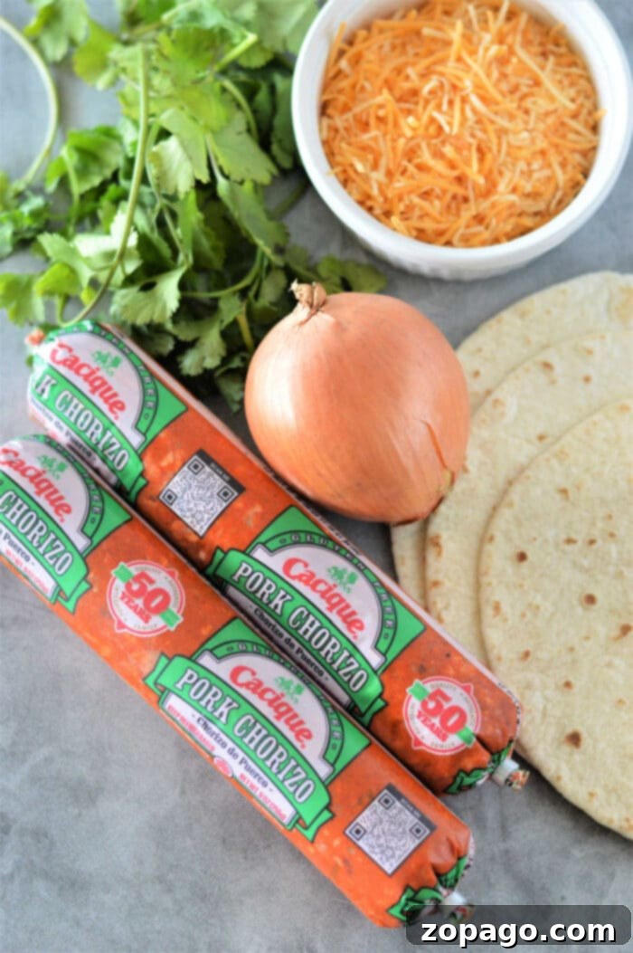 Three chorizo tacos adorned with fresh cilantro and vibrant lime wedges
