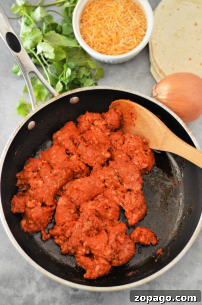 Chorizo and eggs served as a hearty breakfast taco with vibrant garnishes