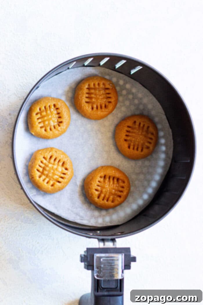 Golden Air Fried Peanut Butter Delights 4 A basket full of air-fried peanut butter cookies with a golden-brown finish, ready to be enjoyed.