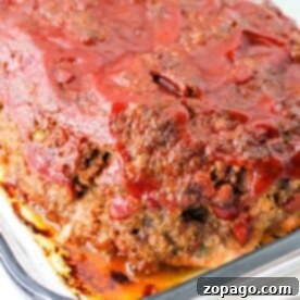 Fiery Meatloaf Bake 6 A freshly baked spicy meatloaf in a glass dish, topped with zesty tomato sauce.