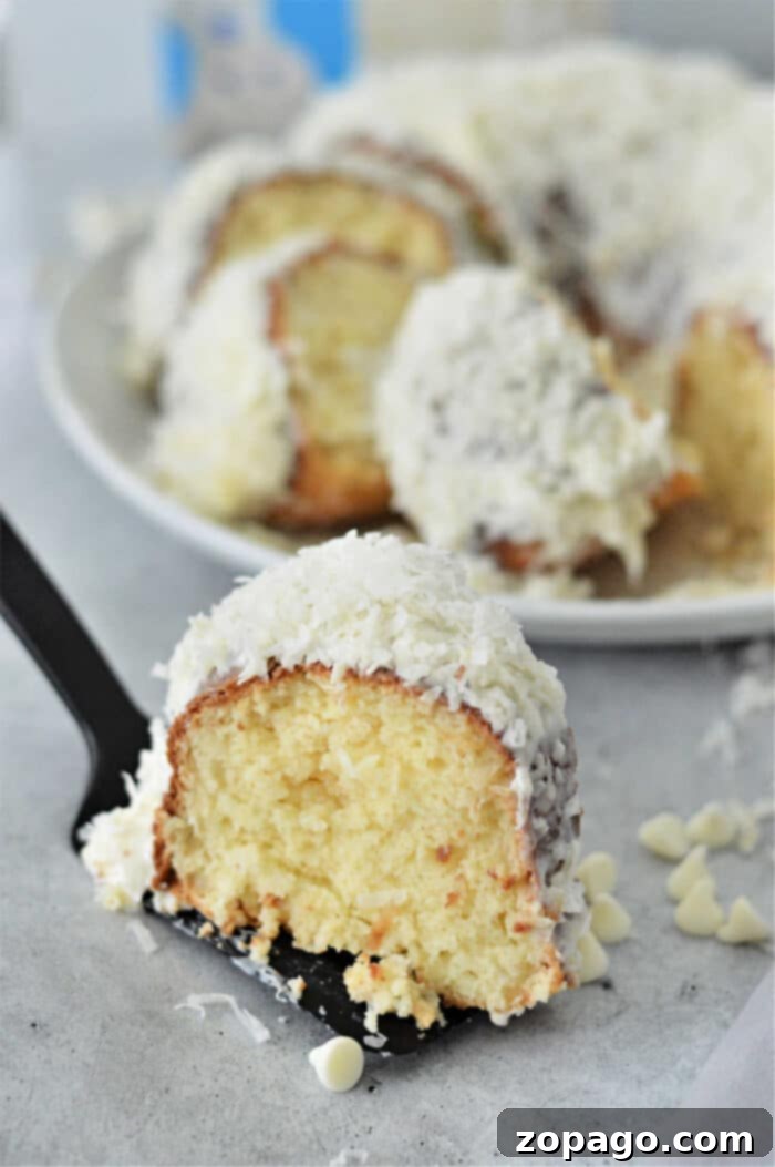 White Chocolate Coconut Bundt Bliss 6 A slice of perfect White Chocolate Coconut Bundt Cake, revealing its moist interior.