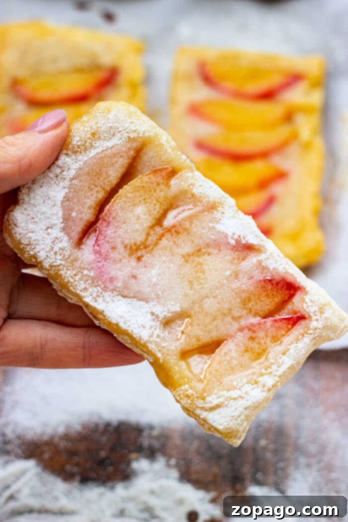 Golden brown peach puff pastry, freshly baked and ready to serve.