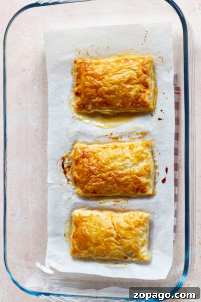 Puff pastry tarts with sliced peaches and a dusting of powdered sugar.