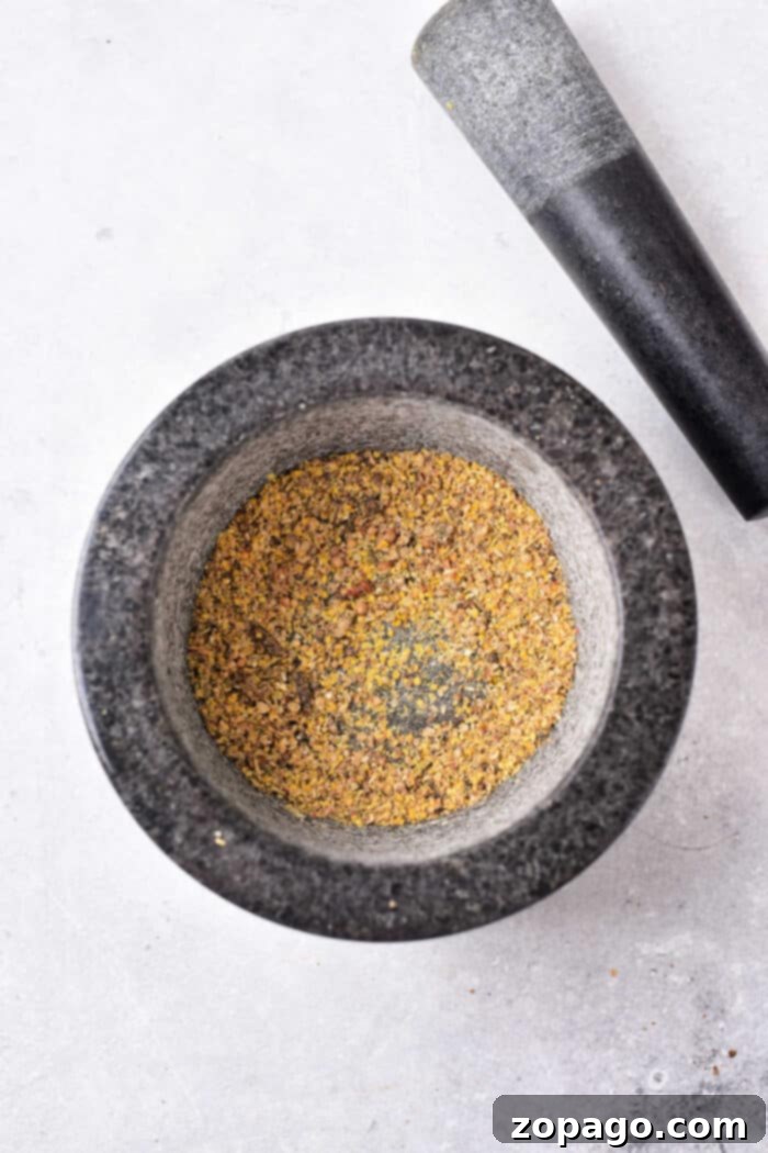 Homemade Corned Beef Spice Blend 5 Close-up of whole spices being toasted in a pan for corned beef seasoning.
