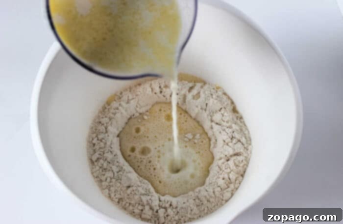 Mixing simple pancake batter, which can also be the base for learning how to make crepes with pancake mix—just add extra milk until you reach the desired thinness.