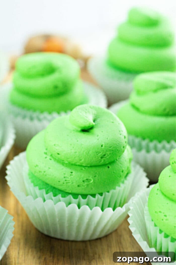Creamy Curd Cupcakes 7 Beautifully frosted Lime Cupcakes arranged on a plate, showcasing their vibrant color and elegant decoration