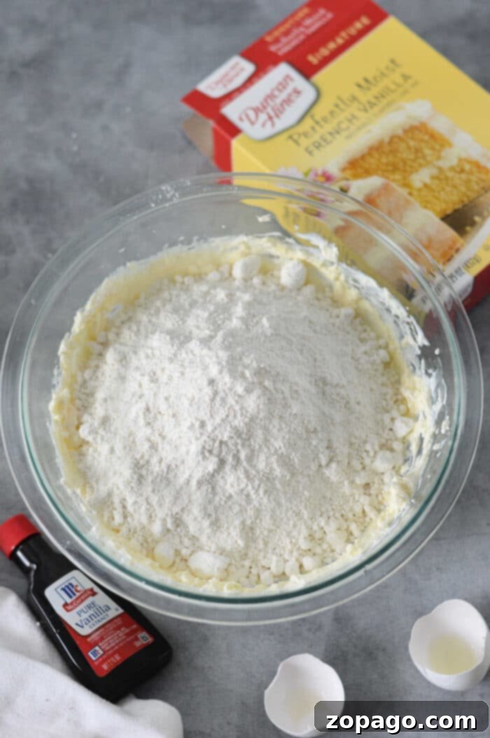 Cream Cheese Velvet Cake Cookies 4 Easy Cream Cheese Cookies Recipe - A batch of freshly baked, golden-brown cookies on a baking sheet, showcasing their soft texture.