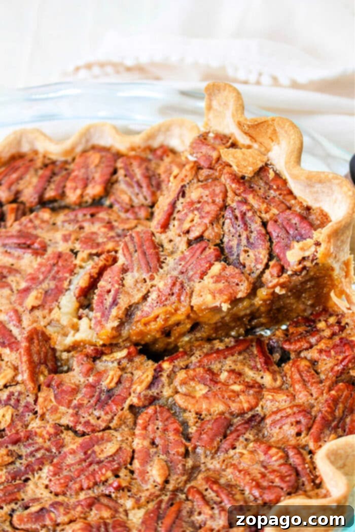 Ultimate Pumpkin Pecan Pie 2 Delightful layered Pumpkin Pecan Pie, a perfect fusion dessert for holiday tables, showcasing its rich pumpkin base and caramelized pecan topping.