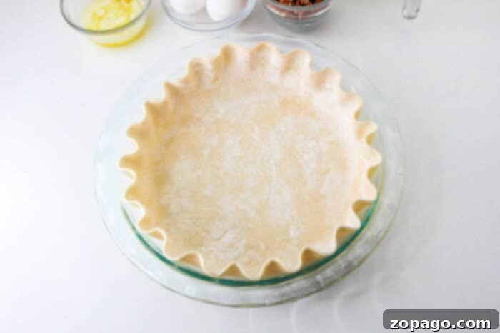 Ultimate Pumpkin Pecan Pie 3 Flaky, golden-brown pie crust waiting to be filled, a crucial component for a delicious homemade pumpkin pecan pie.