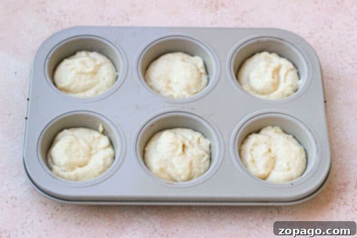 Tender Mayonnaise Biscuits 4 Muffin tin filled with unbaked mayonnaise biscuit batter, ready for the oven.