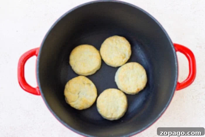 Campfire Biscuits 6 Freshly baked Dutch Oven Biscuits cooling on a wire rack after being removed from the oven.