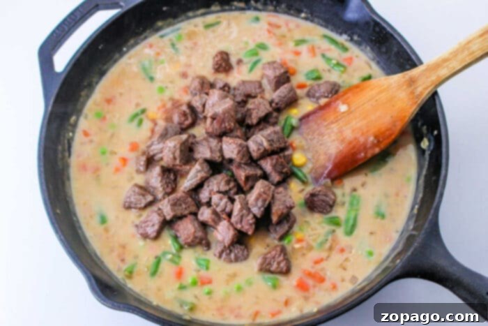 Hearty Steak Pot Pie 5 A serving of Easy Beef Pot Pie, showcasing the golden, flaky crust and chunky, flavorful filling.