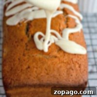 Bursting Cherry Bread 3 Maraschino Cherry Bread, with rich icing drizzling over the loaf cake on a cooling rack, creates a tantalizing display.