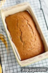 Homemade Cherry Loaf 6 A freshly baked Maraschino Cherry Bread loaf in a rectangular pan cools on a wire rack, inviting you with its sweet and enticing aroma.