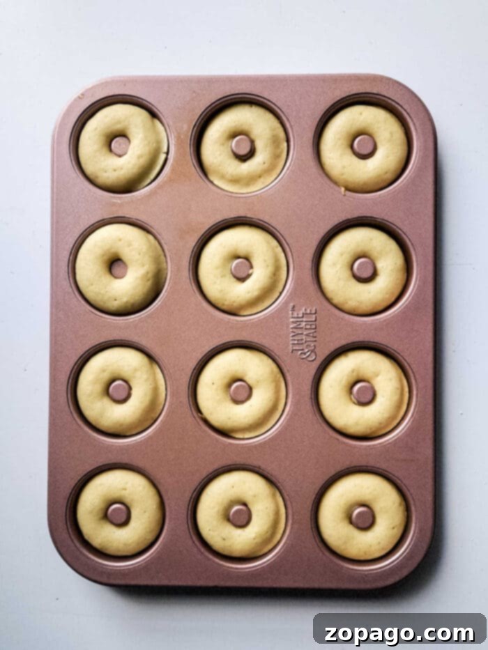 Whip Up Powdered Sugar Donuts 5 Donut batter in a piping bag