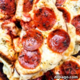 Cheesy Pizza Toast 7 Close-up of Grilled Cheese Pizza Toast featuring pepperoni slices with melted cheese and herbs.
