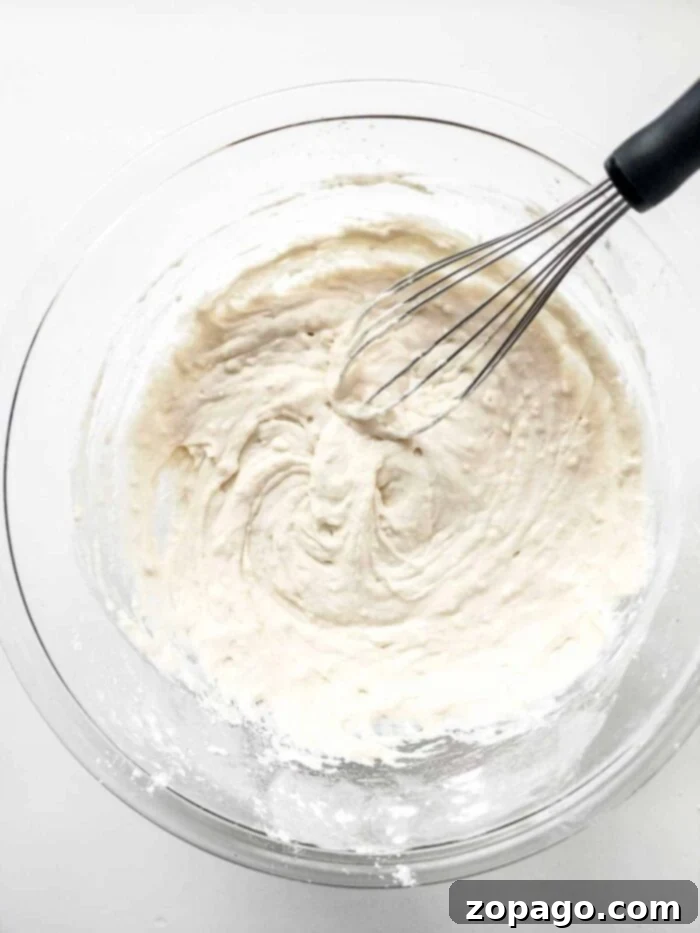 Carnival Funnel Cake Recipe: Close-up of the delicious batter, showing its smooth, pourable consistency, essential for making perfect funnel cakes.