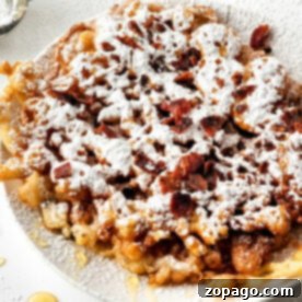 Homemade Funnel Cake Recipe 8 A delightful plate of funnel cake, dusted with powdered sugar and sprinkled with crunchy bacon bits, offers a heavenly taste experience. Perfect for those curious about how to make a funnel cake masterpiece.