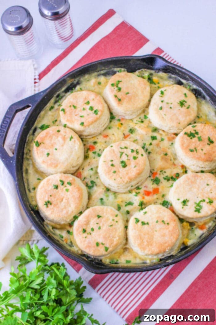 Pillsbury Biscuits baking on top of a bubbling Turkey Pot Pie in an oven-safe dish.