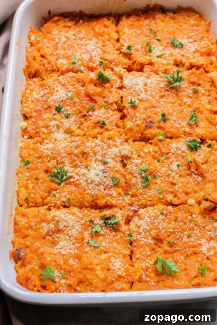 Homestyle Carrot Casserole 2 Baked sweet potato and carrot casserole in a dish, topped with breadcrumbs and fresh herbs, cut into square portions.