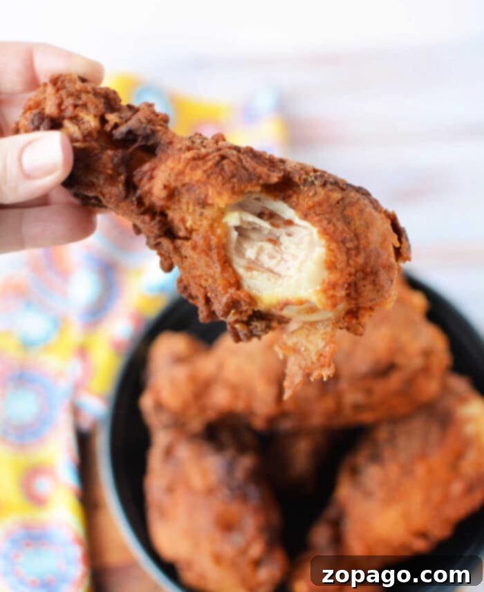 Perfect Oil Temp for Crispy Fried Chicken 2 How Hot Should Oil be for Fried Chicken – A close-up of golden, crispy fried chicken pieces in a cast iron skillet, emphasizing the perfect texture achieved by correct oil temperature.