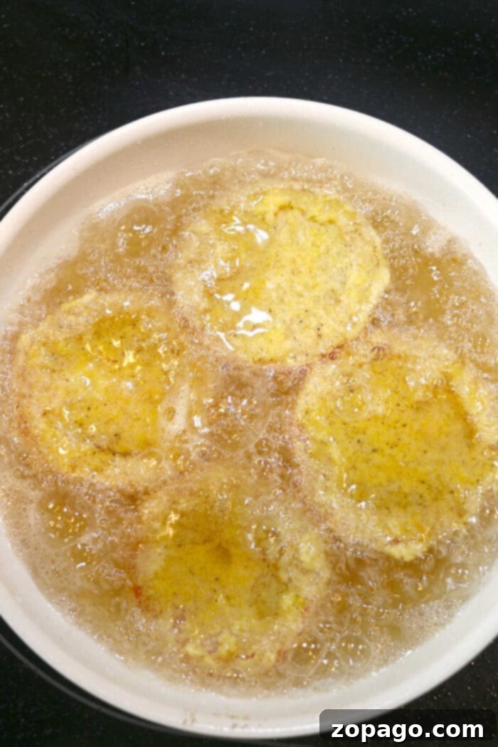 Perfect Oil Temp for Crispy Fried Chicken 4 Optimal Oil Temperature for Frying Food – A close-up of a digital thermometer accurately measuring the temperature of hot oil in a deep pot, essential for perfect frying.