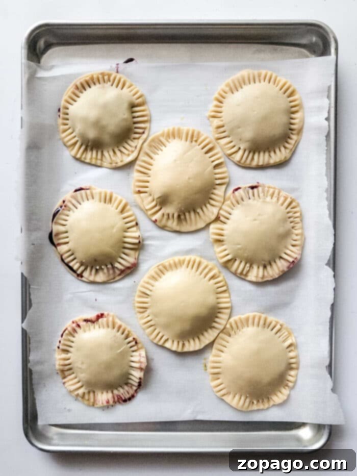 Air-Fried Blueberry Hand Pies 5 Hand Pies with Pie Filling - A platter of perfectly baked hand pies, some with glaze, showcasing their golden crusts and inviting appearance.