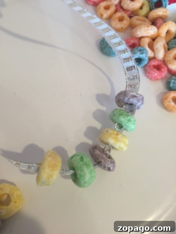 Engaging Mardi Gras crafts for kids that are easy and inexpensive, using cereal. Also, a delicious King cupcake recipe kids will love to make. Mardi Gras crafts for preschoolers: Cereal necklace making activity.