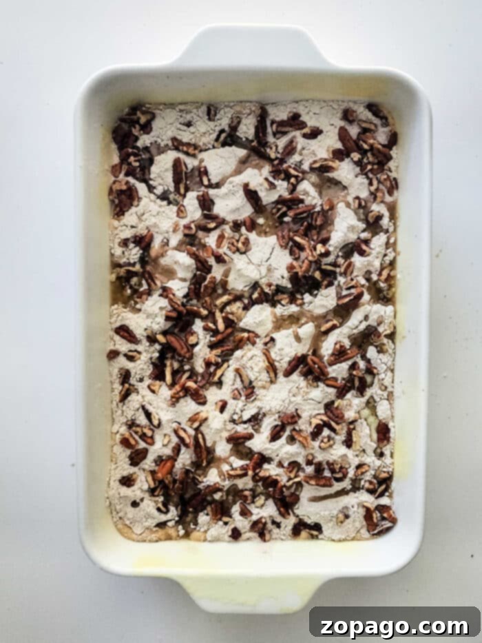 Spiced Sweet Potato Dump Cake 5 A warm, inviting sweet potato dump cake with a generous pecan topping, ready for a scoop of ice cream.