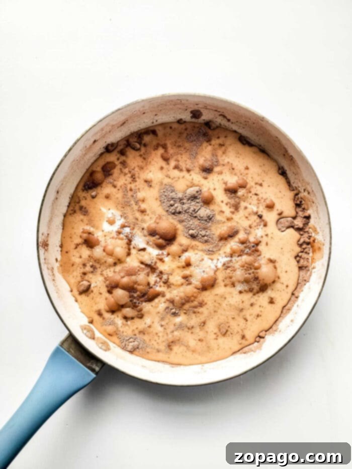 Chocolate Drenched Biscuit Dreams 4 dairy free chocolate gravy in a pan, showcasing its smooth consistency.