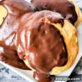 Chocolate Drenched Biscuit Dreams 6 biscuits draped in glossy chocolate gravy await your indulgence on a pristine white plate.