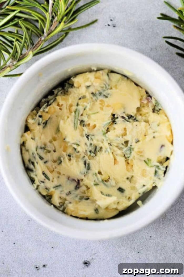 Homemade Cowboy Butter 2 Garlic cowboy butter in a ramekin, garnished with fresh herbs, ready to serve with steak.
