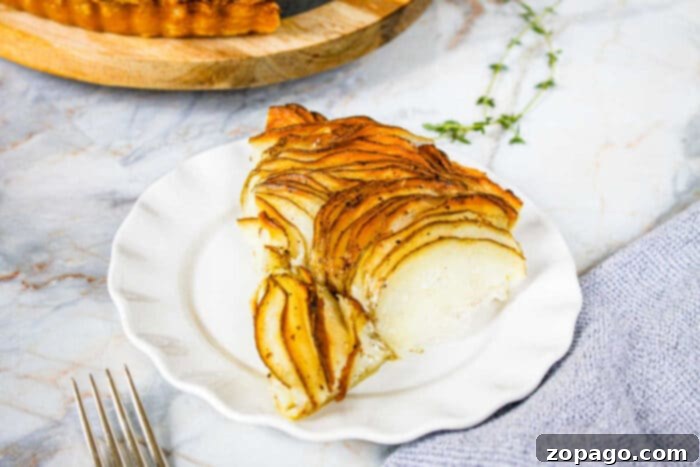 Rustic Russet Potato Galette 7 Individual slice of baked potato tart on a white serving plate