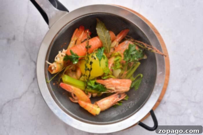 Homemade seafood broth simmering on the stove
