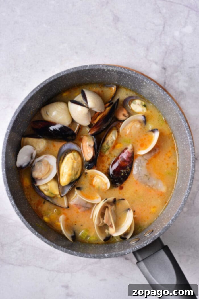 Zesty Mussel Stew 3 Delicious and inviting soup with mussels, shrimp, and vegetables, served in a rustic bowl.