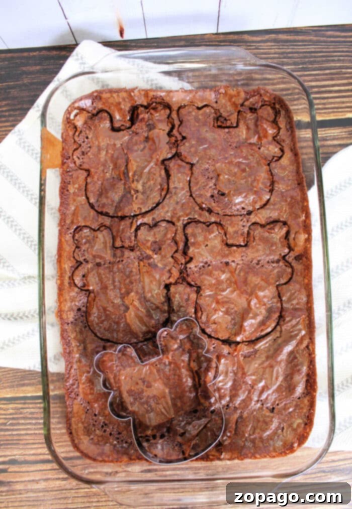 Santa's Favorite Brownies 5 Reindeer Dessert: A close-up of a decorated reindeer brownie on a wooden surface.