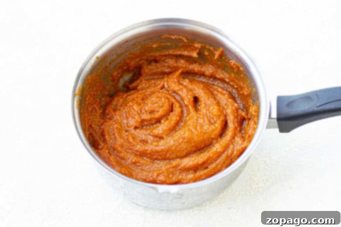 Pectin-Free Homemade Pumpkin Jam 5 Smooth and creamy pumpkin spread in a glass jar, ready to be enjoyed.