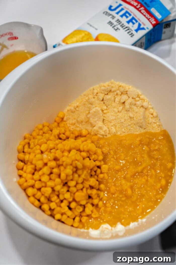 Effortless Cheesy Corn Bake 5 Small batch corn casserole with a scoop removed, showcasing its moist and fluffy texture.