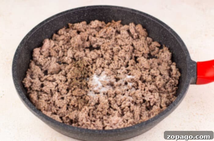 Hamburger Casserole 3 A delicious Ground Beef Casserole with a creamy, cheesy topping, served fresh from the oven.