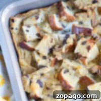 Easy and comforting raisin bread pudding, served warm with a dusting of powdered sugar.