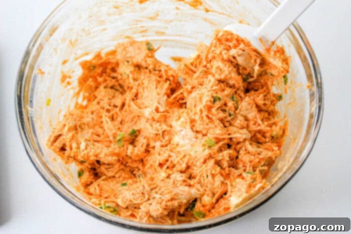 Shredded buffalo chicken mixture, ready for the crescent roll ring